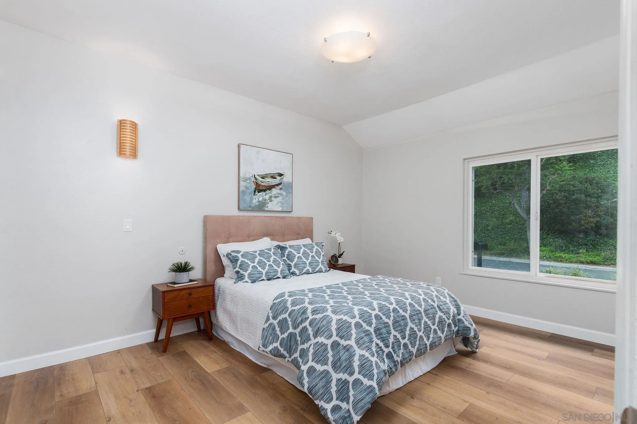 1863 Caminito Quintero La Jolla, CA 92037 - Photo 16 of 27 a bedroom with a bed and a window