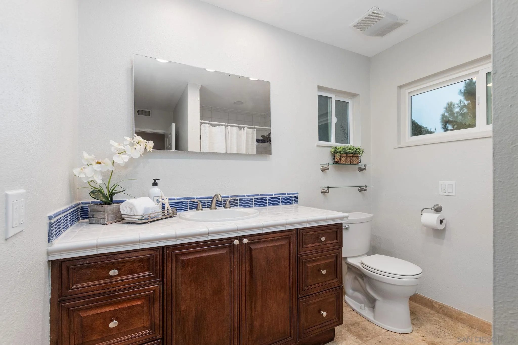 1863 Caminito Quintero La Jolla, CA 92037 - Photo 17 of 27 a bathroom with a granite countertop toilet sink and mirror