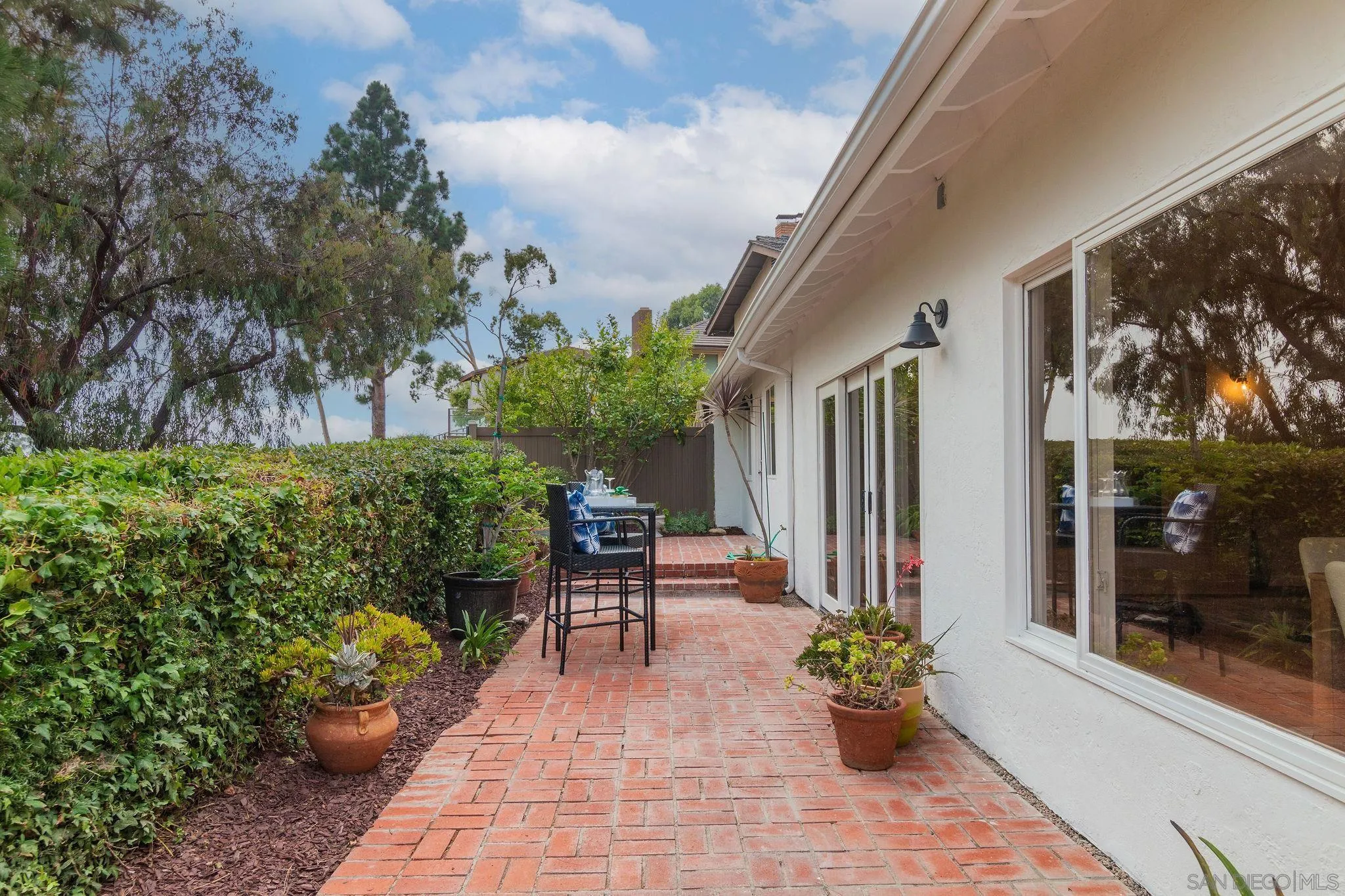 1863 Caminito Quintero La Jolla, CA 92037 - Photo 19 of 27 a garden with chairs and a potted plant