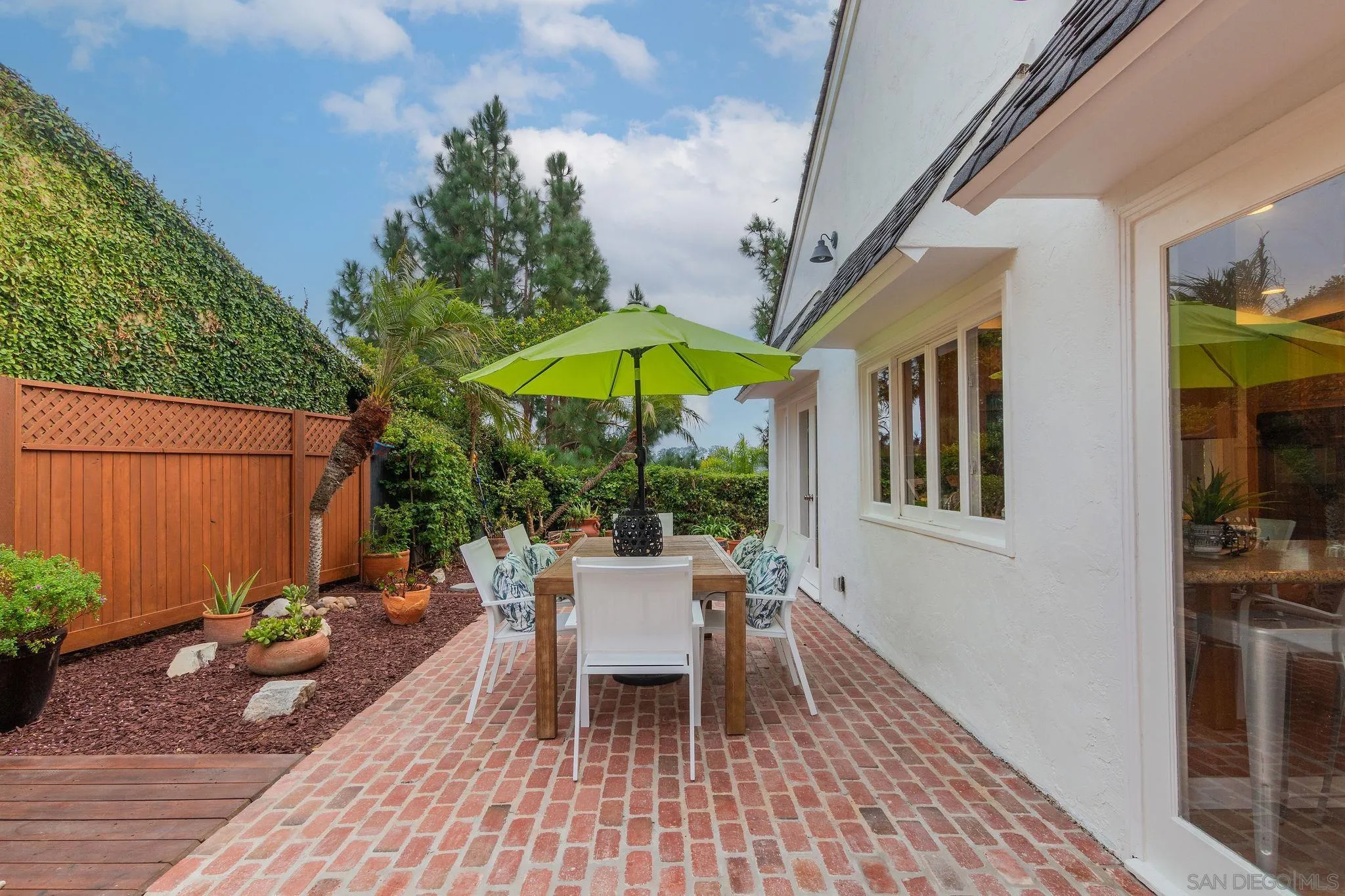 1863 Caminito Quintero La Jolla, CA 92037 - Photo 21 of 27 a view of a house with backyard sitting area and furniture