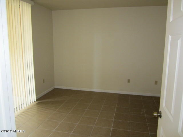1825 West Ray Road, Unit 1110 Chandler, AZ 85224 - Photo 4 of 9 a view of an empty room and window