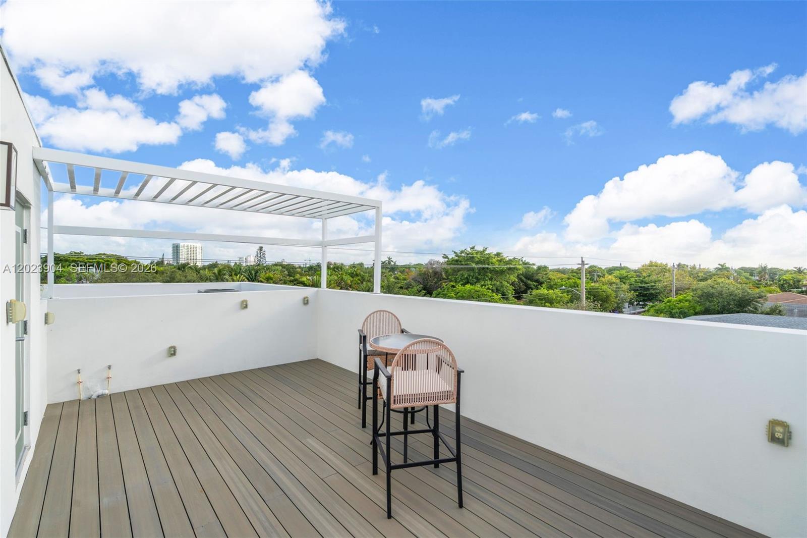 721 Southwest 11th Street, Unit G Miami, FL 33129 - Photo 31 of 40 a view of a terrace with wooden floor and fence