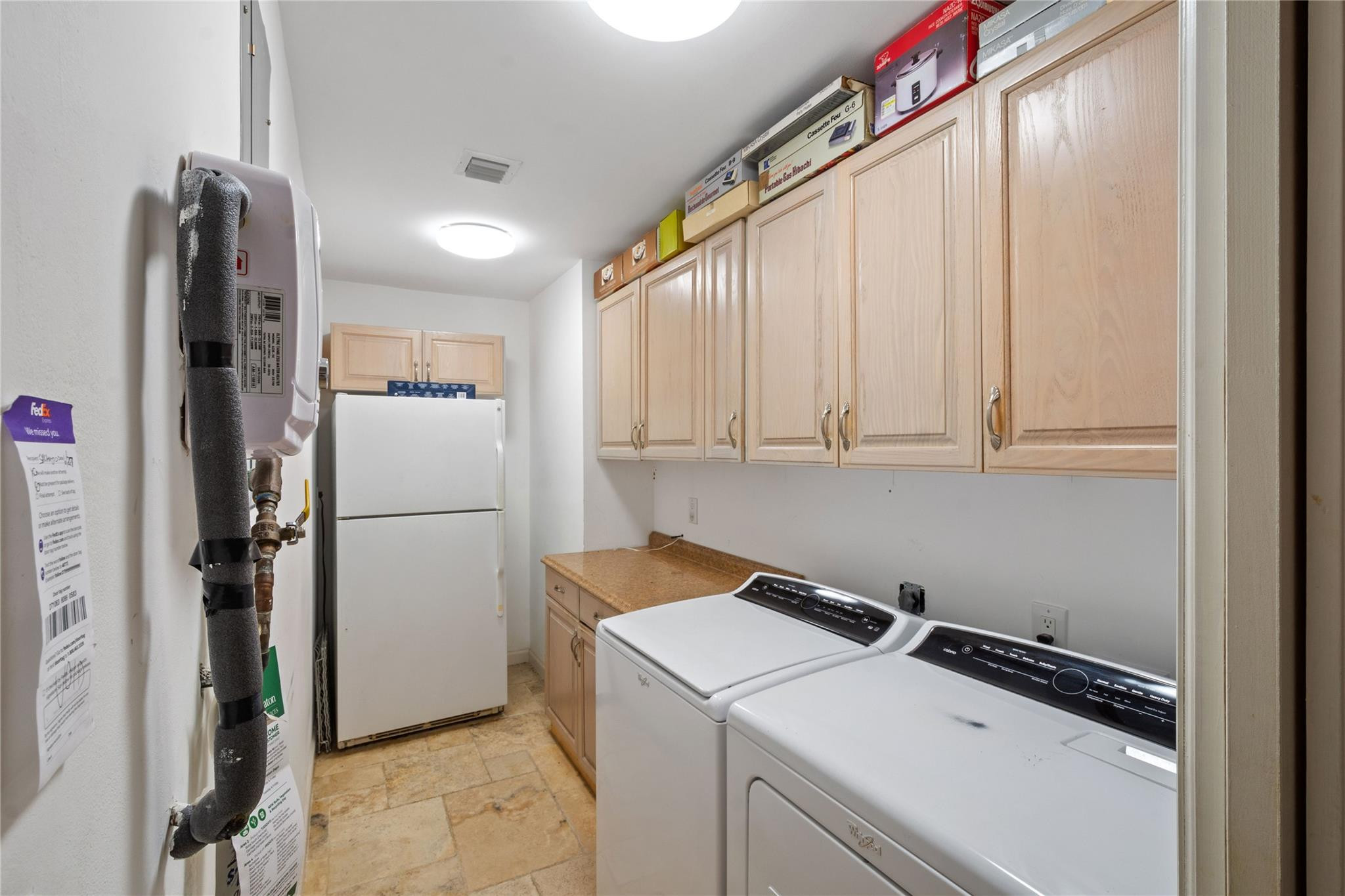 6832 Viento Way Boca Raton, FL 33433 - Photo 8 of 31 a view of a storage and utility room with a fridge