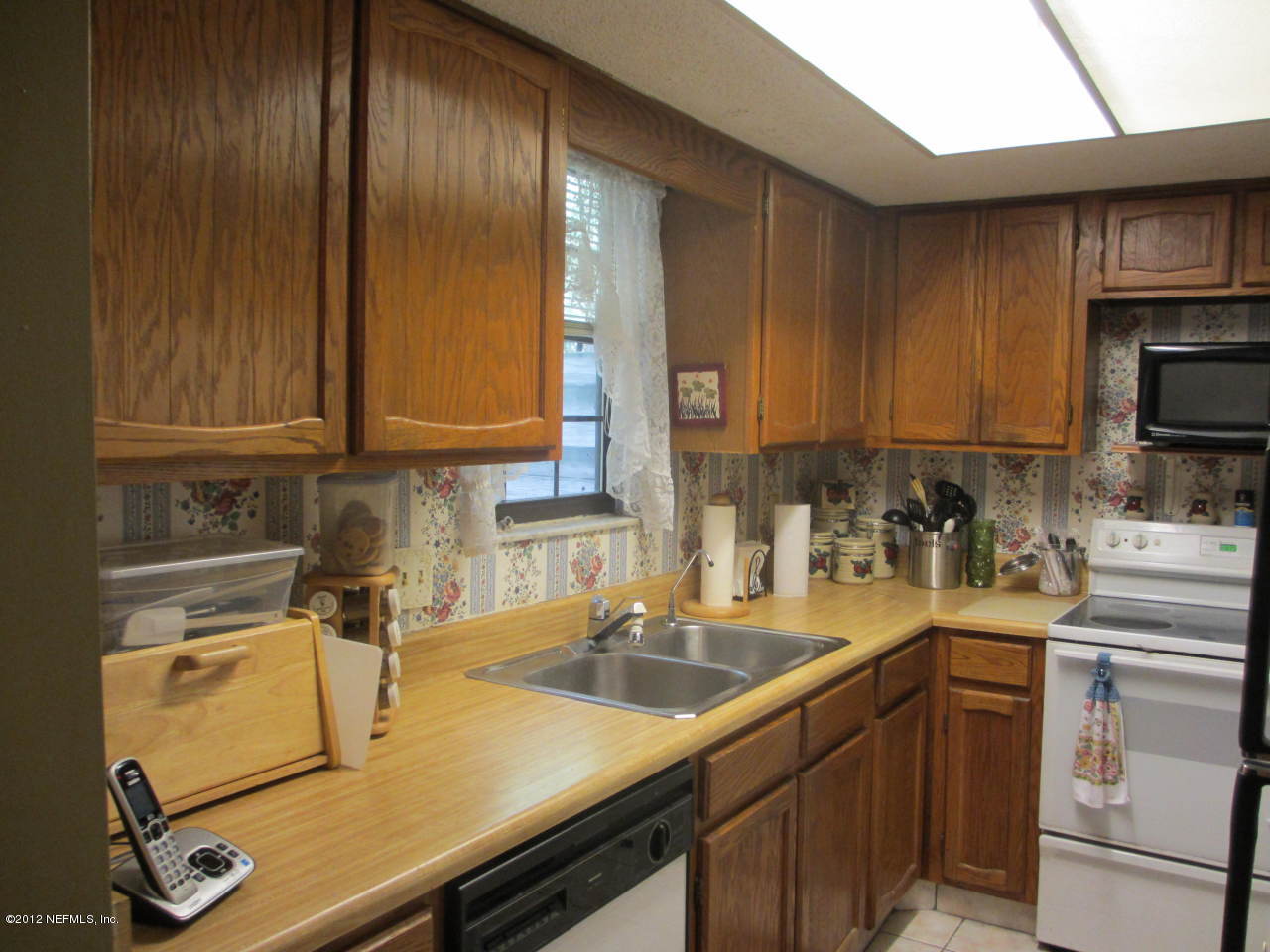 1303 Kettering Way Orange Park, FL 32073 - Photo 11 of 24 a kitchen with a sink cabinets and appliances