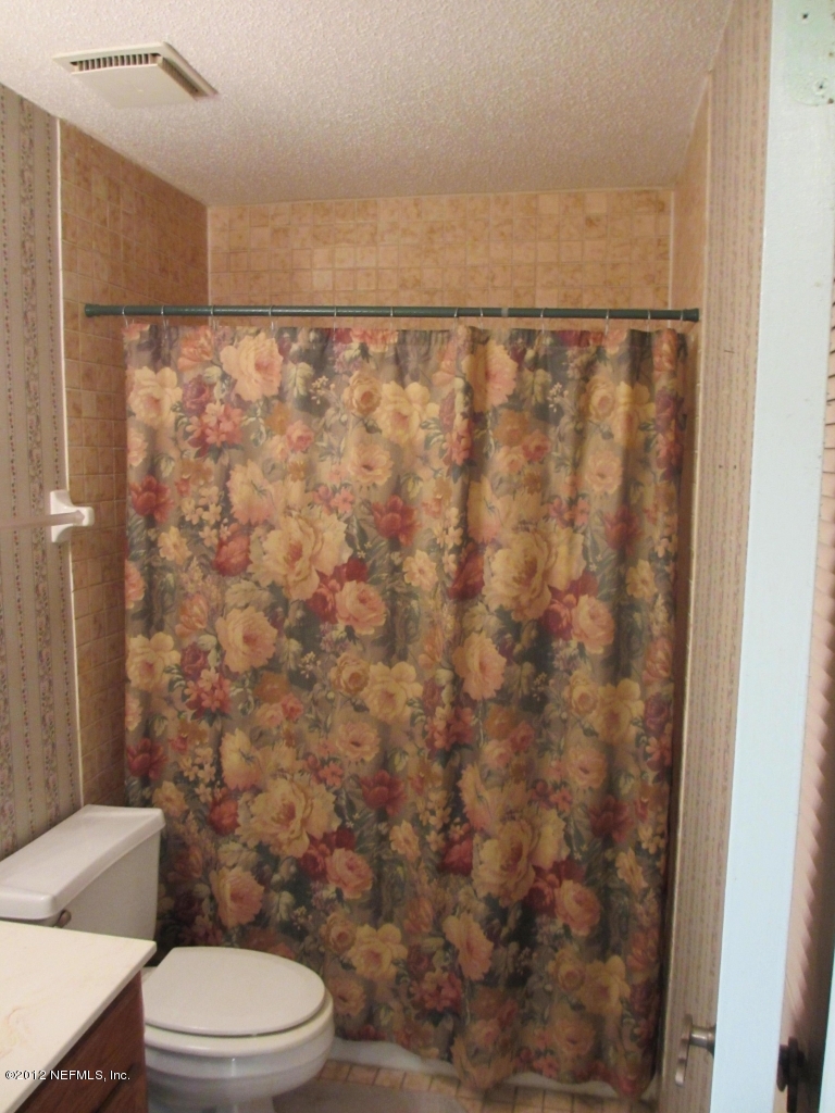 1303 Kettering Way Orange Park, FL 32073 - Photo 20 of 24 a bathroom with a toilet and a shower