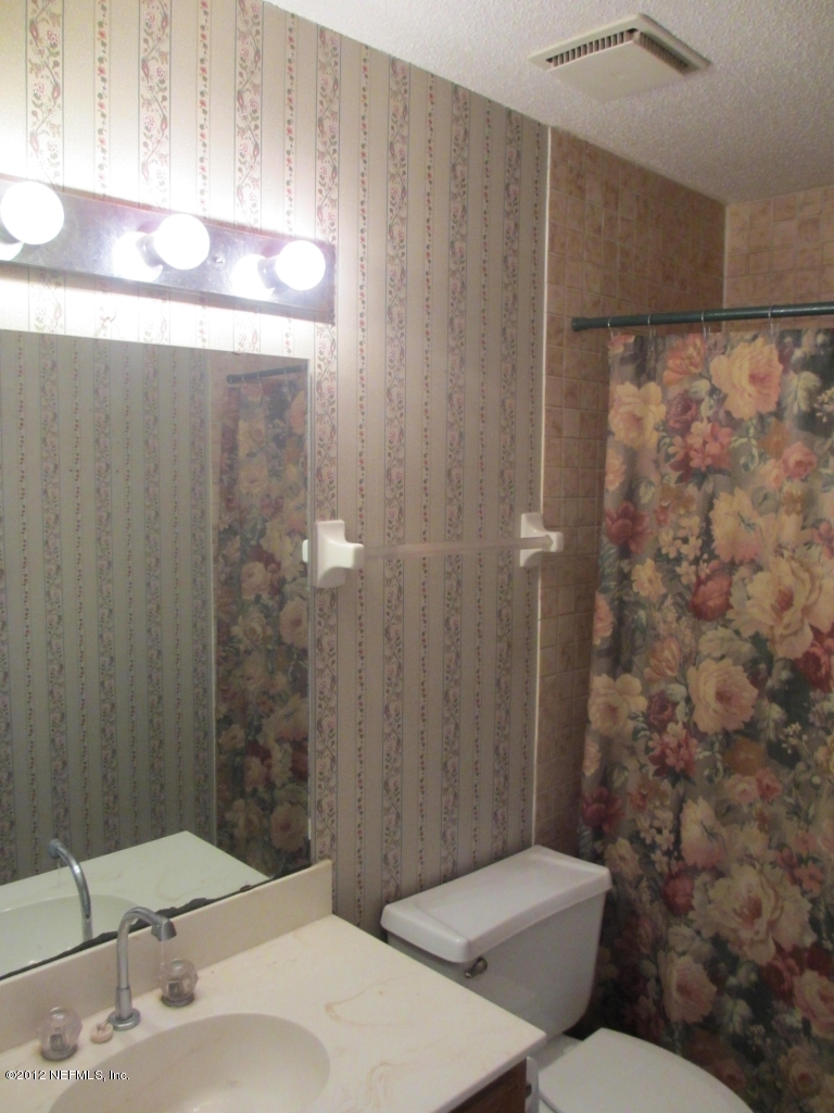 1303 Kettering Way Orange Park, FL 32073 - Photo 21 of 24 a bathroom with a sink a toilet and shower