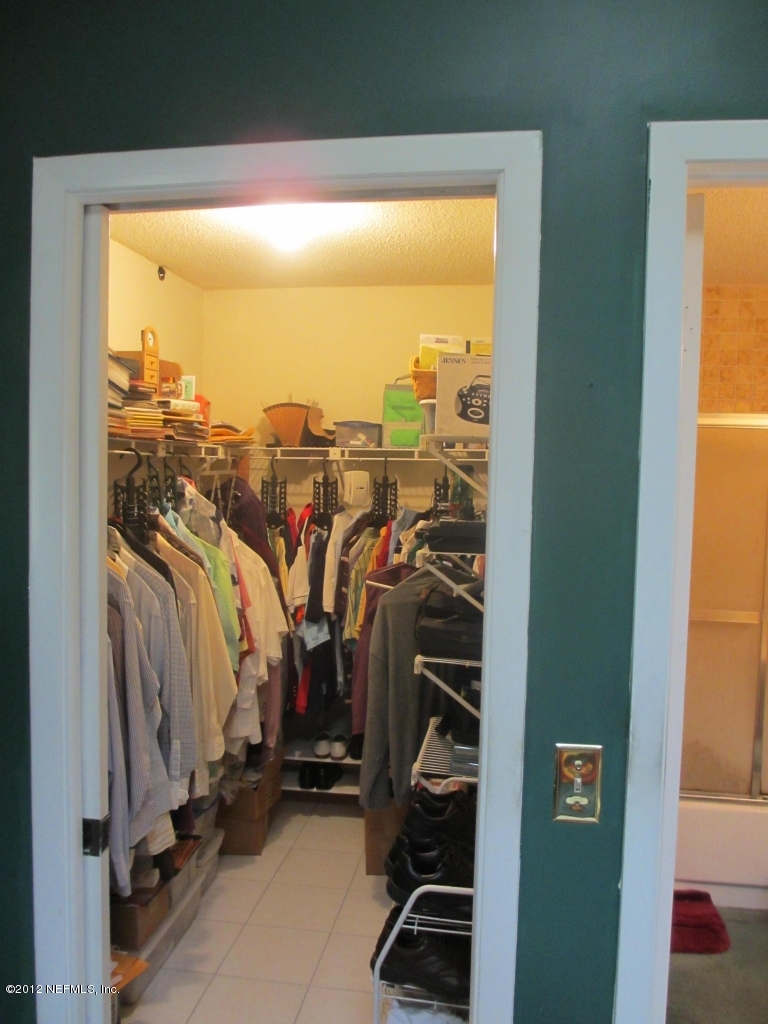 1303 Kettering Way Orange Park, FL 32073 - Photo 23 of 24 a view of walk in closet with clothes and shoes