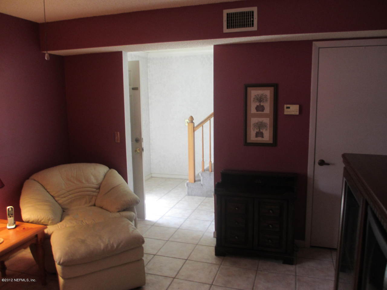 1303 Kettering Way Orange Park, FL 32073 - Photo 4 of 24 a living room with furniture and a refrigerator