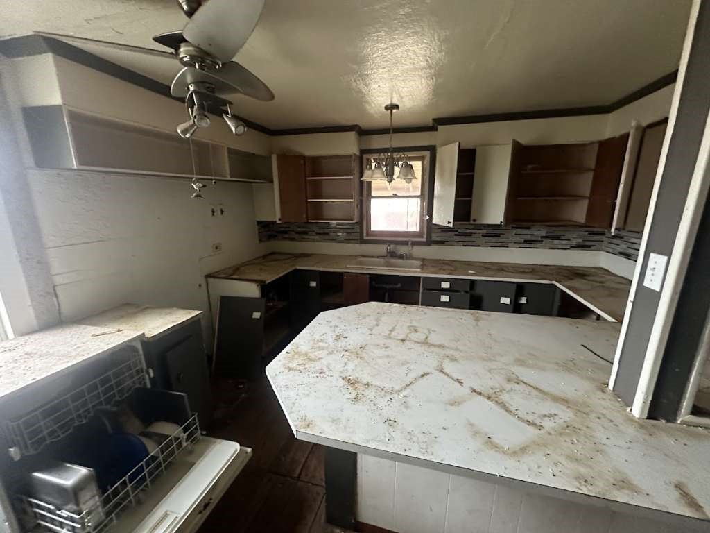 516 East Madison Street Lubbock, TX 79403 - Photo 12 of 18 a kitchen with a stove a sink and a refrigerator