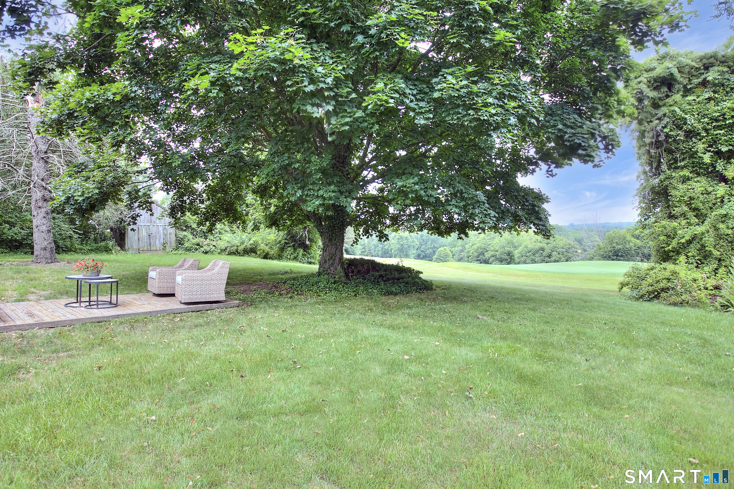 324 Ridge Road Orange, CT 06477 - Photo 31 of 38 a view of a chair and table of the back yard