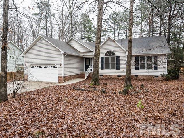 7201 Cedric Drive Raleigh, NC 27603 - Photo 1 of 25 a front view of a house with a yard and garage