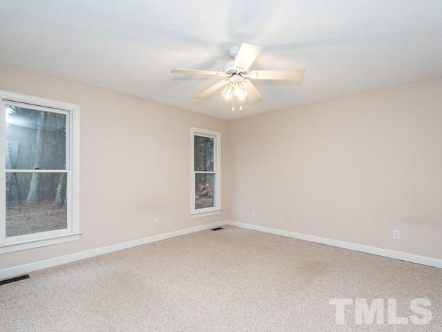 7201 Cedric Drive Raleigh, NC 27603 - Photo 13 of 25 an empty room with a window and a fan
