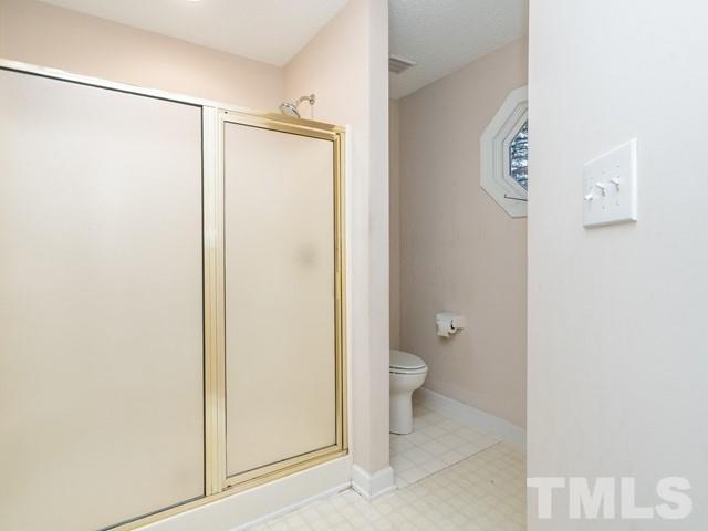 7201 Cedric Drive Raleigh, NC 27603 - Photo 17 of 25 a bathroom with a granite countertop shower and a toilet