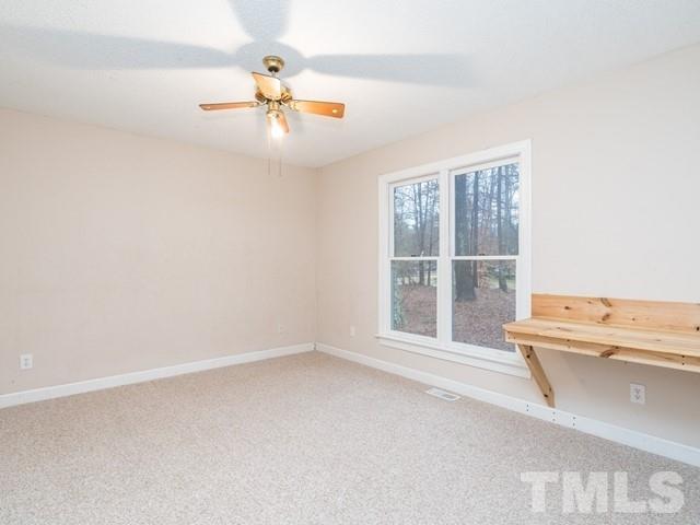 7201 Cedric Drive Raleigh, NC 27603 - Photo 20 of 25 an empty room with a window and ceiling fan