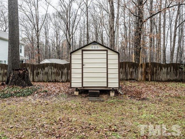 7201 Cedric Drive Raleigh, NC 27603 - Photo 23 of 25 a wooden house with trees in front of it