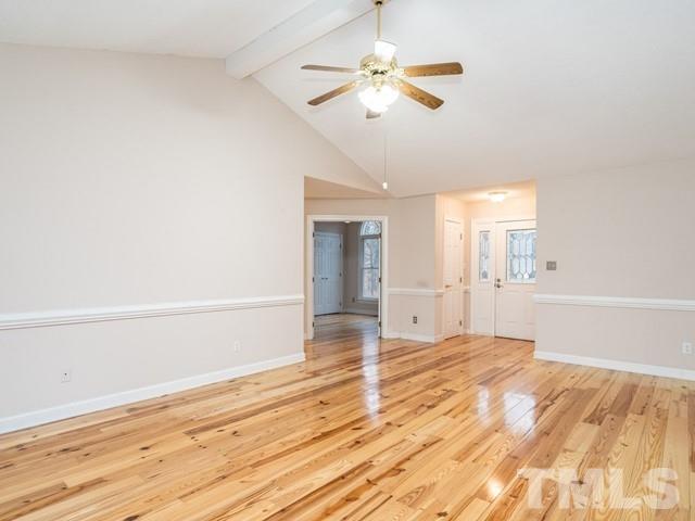 7201 Cedric Drive Raleigh, NC 27603 - Photo 4 of 25 an empty room with wooden floor fan and windows