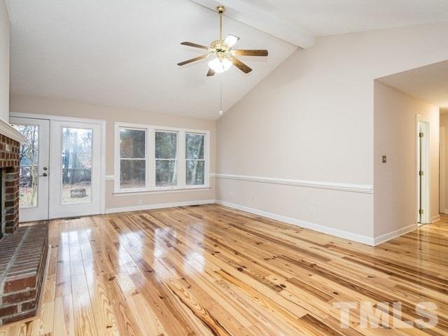 7201 Cedric Drive Raleigh, NC 27603 - Photo 5 of 25 a view of an empty room with wooden floor and a window