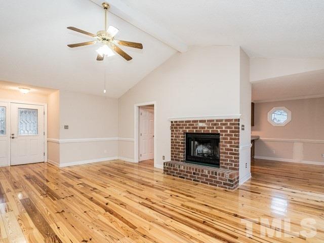 7201 Cedric Drive Raleigh, NC 27603 - Photo 6 of 25 a bedroom with a bed and a fireplace