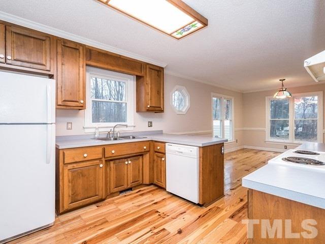 7201 Cedric Drive Raleigh, NC 27603 - Photo 7 of 25 a kitchen with stainless steel appliances granite countertop a sink stove and refrigerator