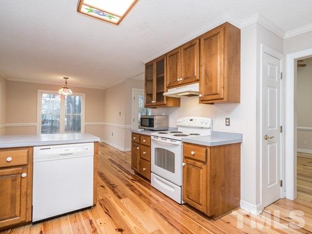 7201 Cedric Drive Raleigh, NC 27603 - Photo 9 of 25 a kitchen with stainless steel appliances granite countertop a stove sink and cabinets