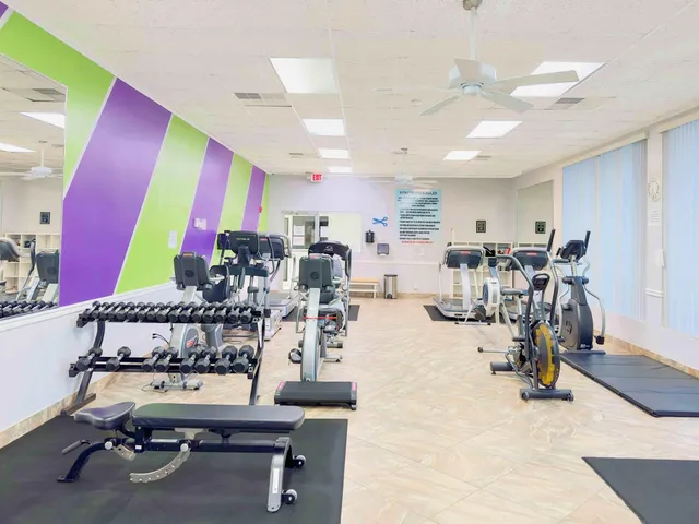 a room with lots of chairs and mirrors