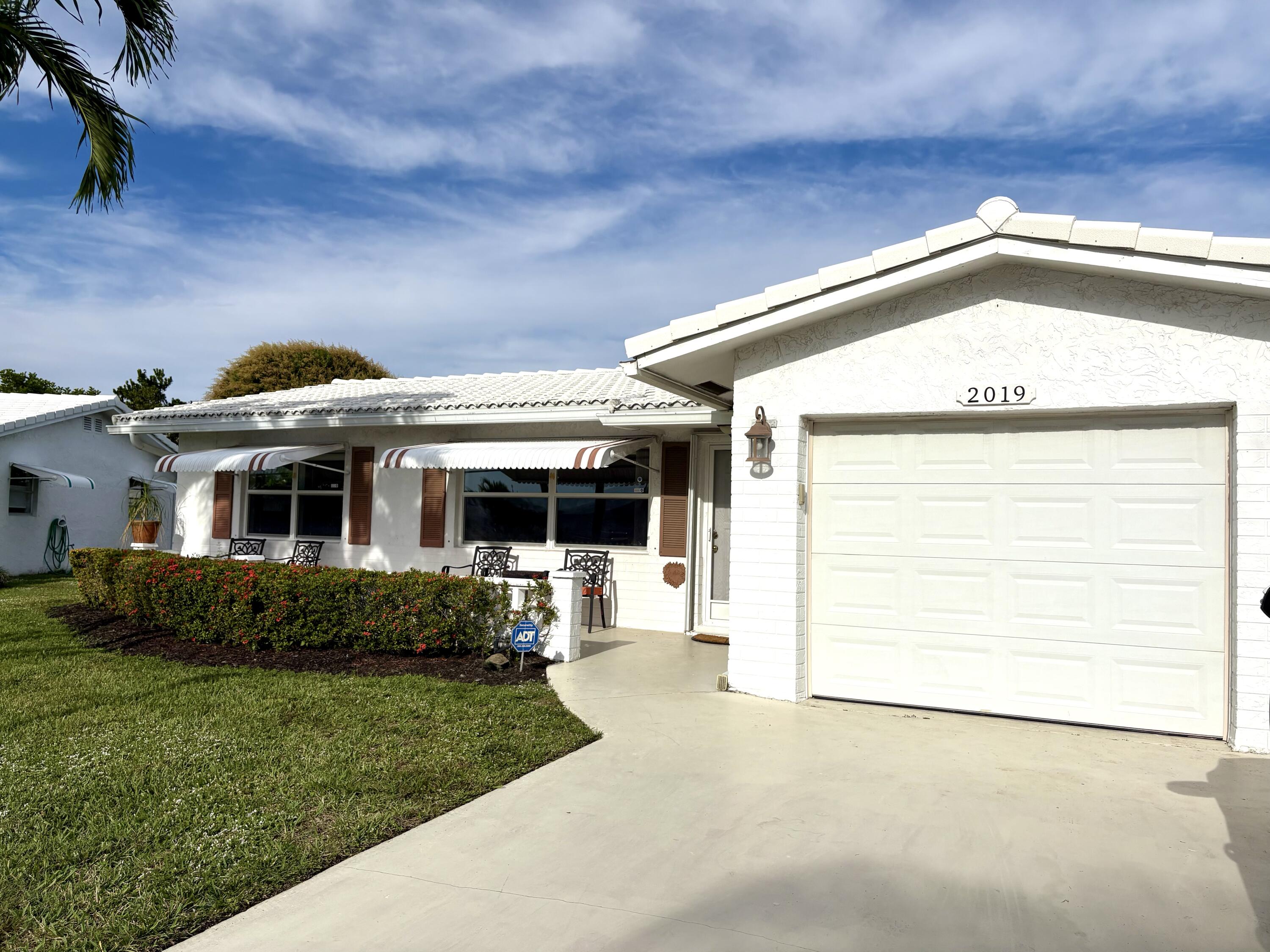 2019 Southwest 18th Drive Boynton Beach, FL 33426 - Photo 2 of 17 a view of a house with a garden