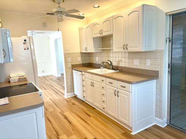 a kitchen with a sink stove and refrigerator