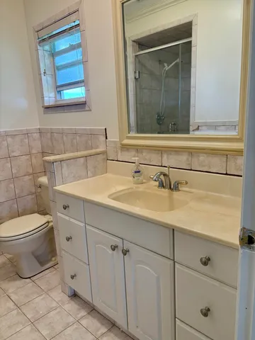 a bathroom with a toilet sink and mirror