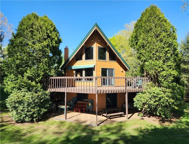 a view of a house with a yard and deck