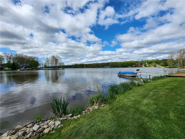 a lake view with tables and chairs