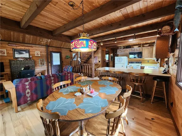 a dining room with furniture and wooden floor