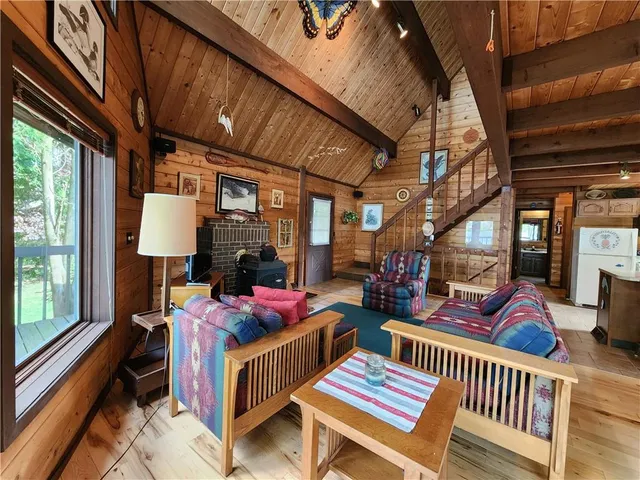 a living room with furniture a rug and a window