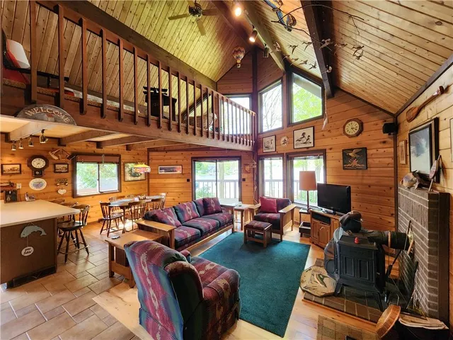 a room with furniture pool table wooden floor and window