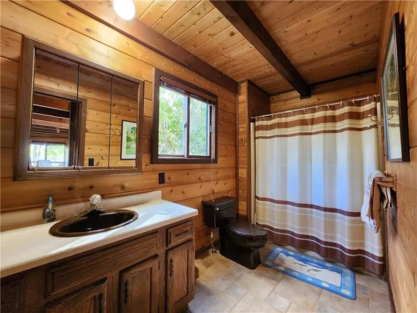 a bedroom with 2 bed and a large window