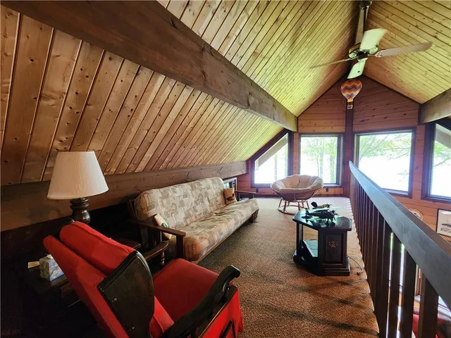 a bedroom with a bed and a dresser next to a window