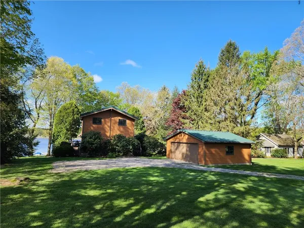 a view of a wooden house with a yard