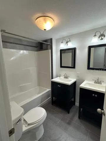 a bathroom with a sink a toilet and bathtub