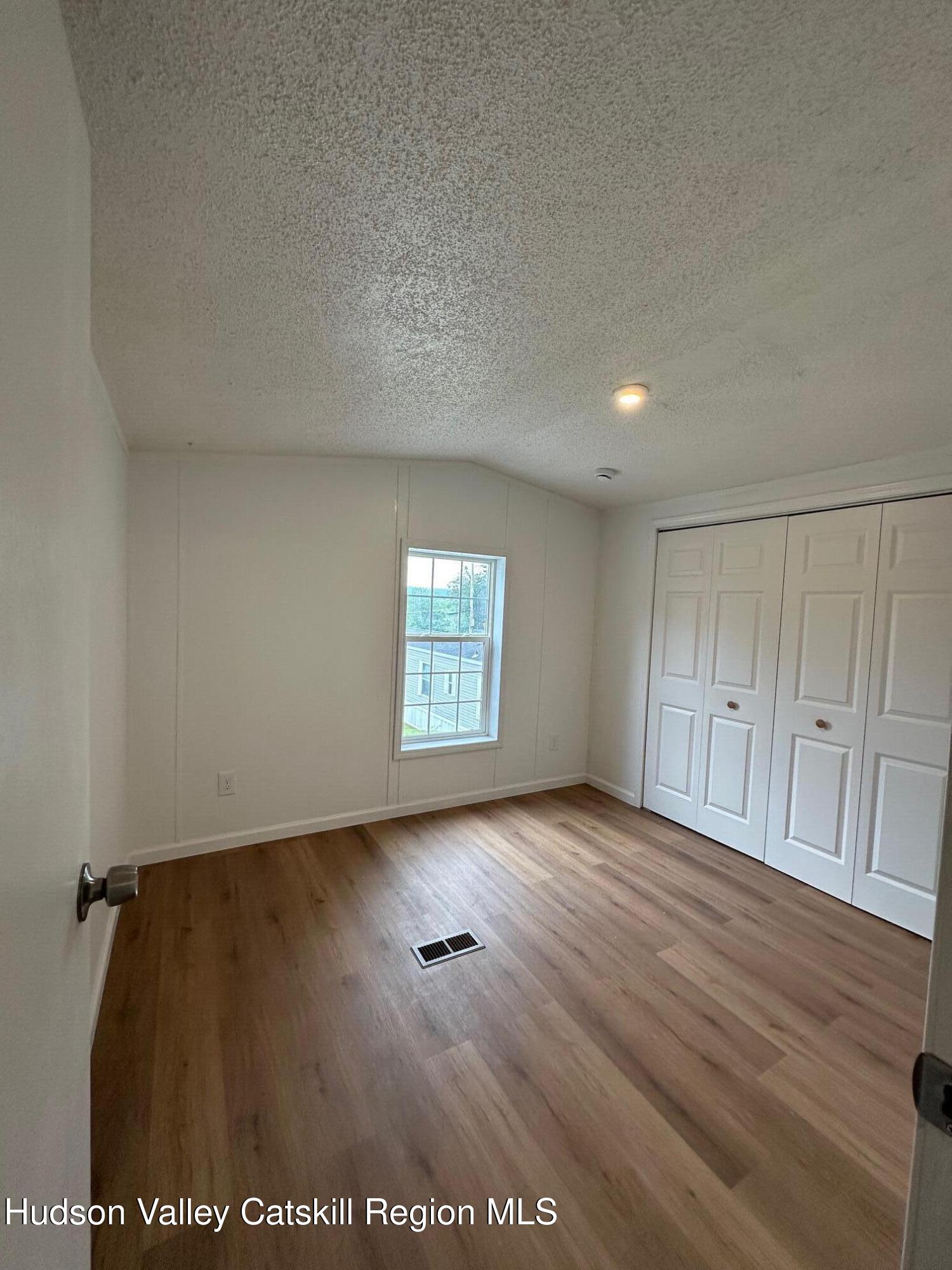 2699 Highway 22, Unit 2 Patterson, NY 12563 - Photo 11 of 11 an empty room with wooden floor and windows