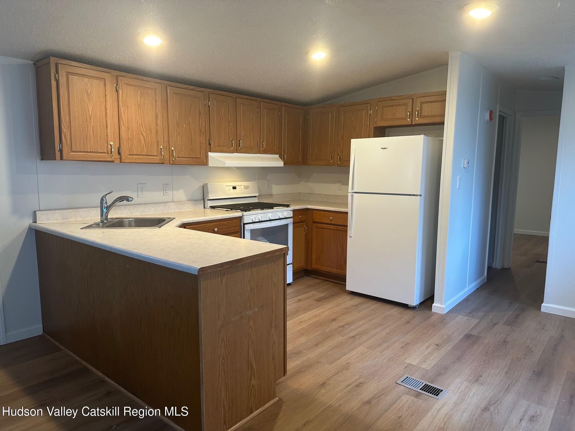 2699 Highway 22, Unit 2 Patterson, NY 12563 - Photo 5 of 11 a kitchen with a refrigerator sink and cabinets