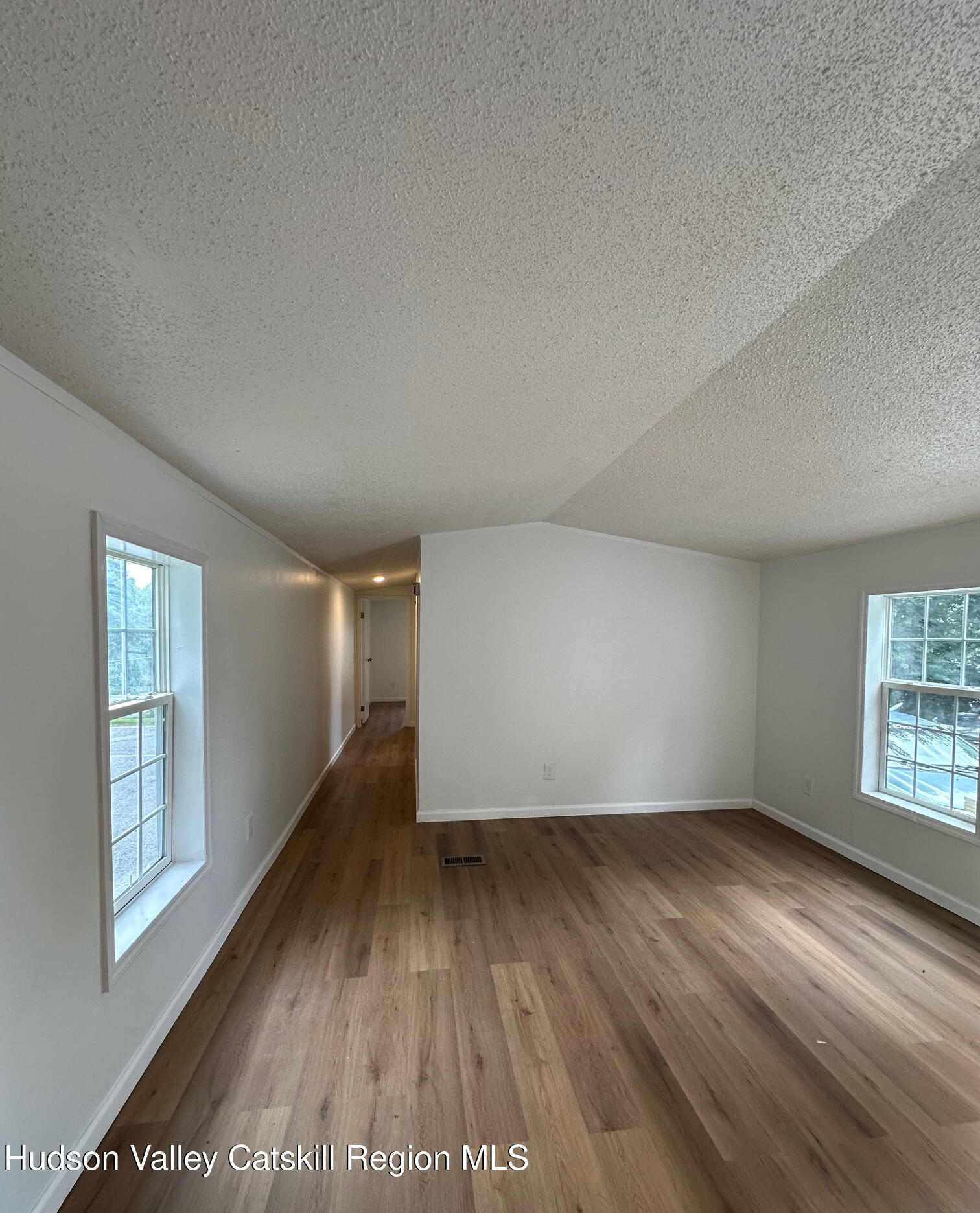 2699 Highway 22, Unit 2 Patterson, NY 12563 - Photo 6 of 11 an empty room with wooden floor and windows