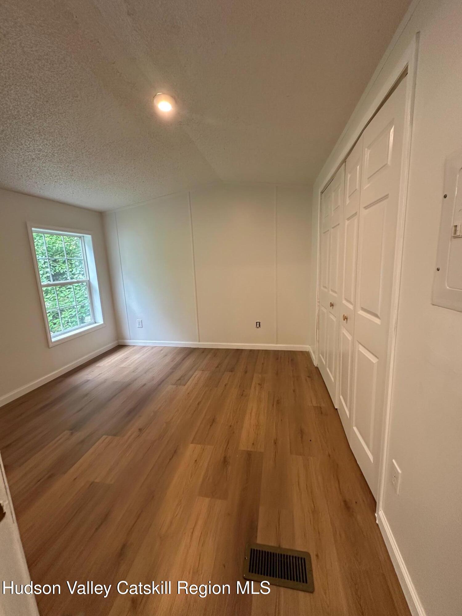 2699 Highway 22, Unit 2 Patterson, NY 12563 - Photo 8 of 11 wooden floor in an empty room with a window