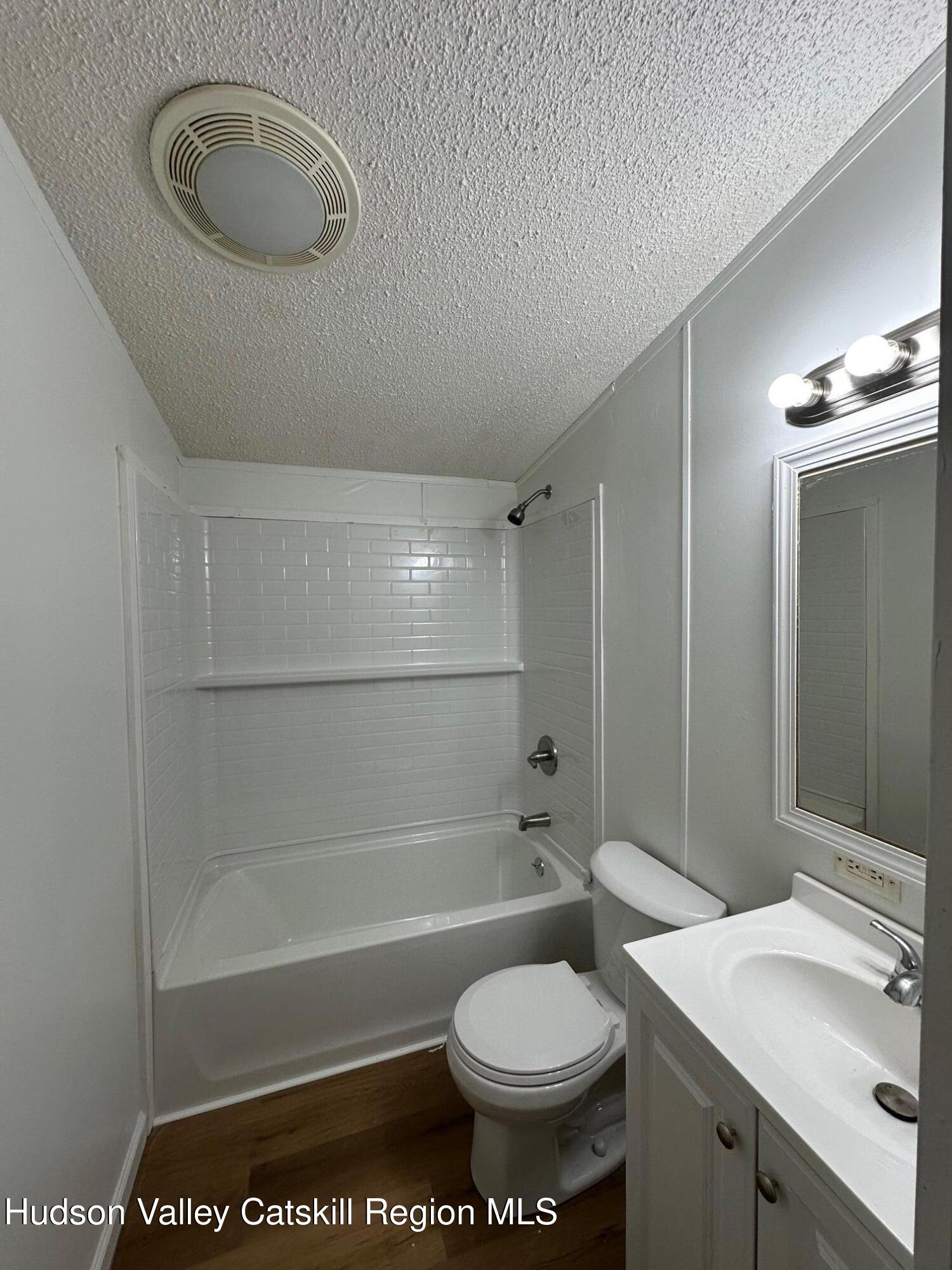 2699 Highway 22, Unit 2 Patterson, NY 12563 - Photo 10 of 11 a bathroom with a toilet a sink and bathtub