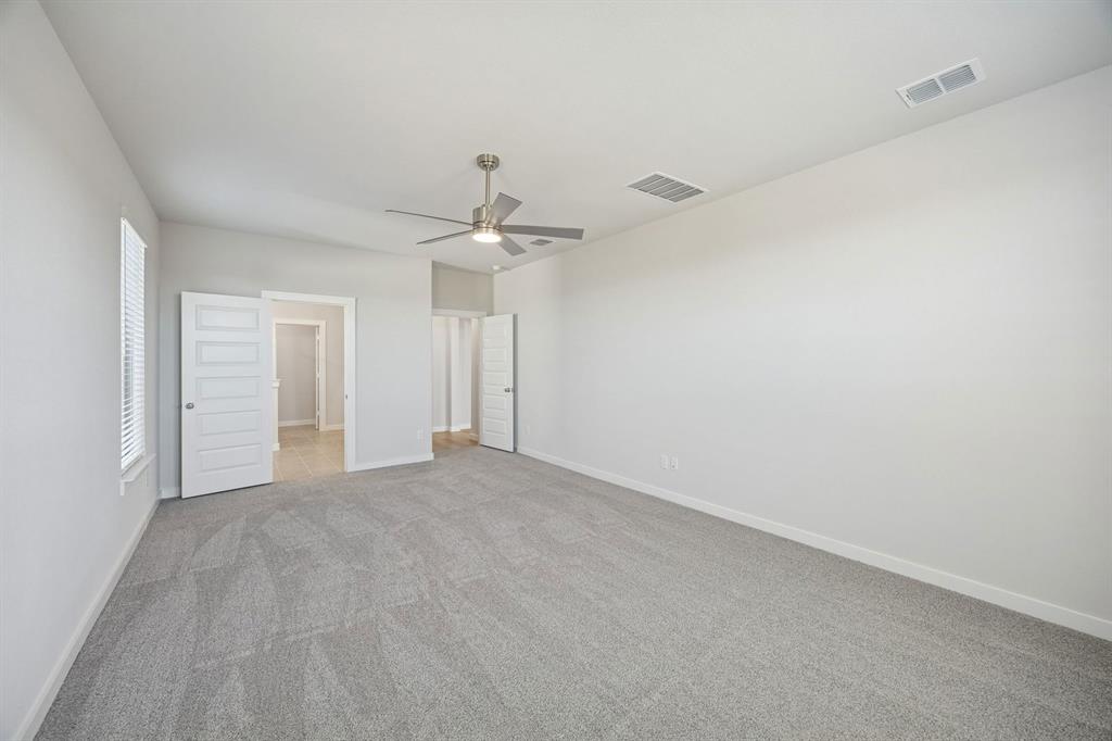 1461 Companero Street Haslet, TX 76052 - Photo 14 of 35 a view of an empty room with a chandelier fan