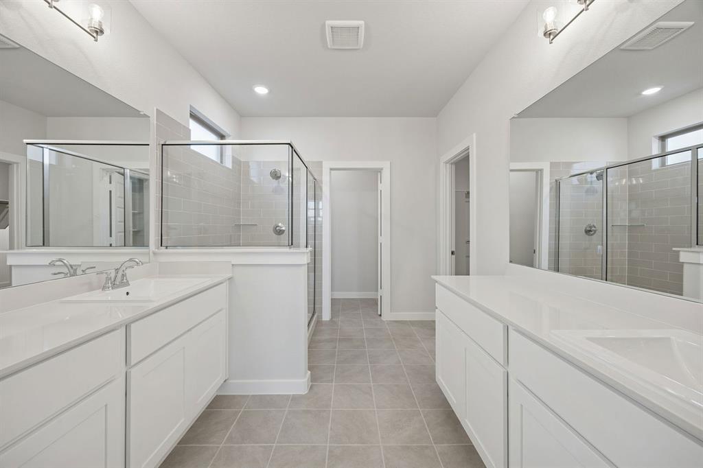 1461 Companero Street Haslet, TX 76052 - Photo 15 of 35 a bathroom with a shower sink and mirror