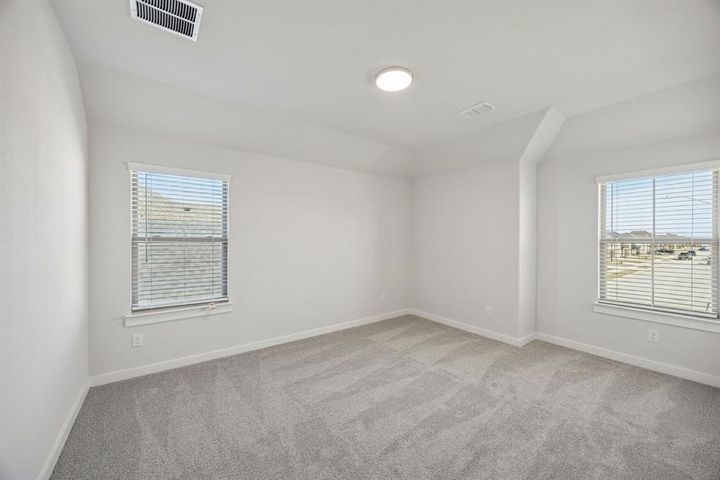 1461 Companero Street Haslet, TX 76052 - Photo 25 of 35 an empty room with windows and closet