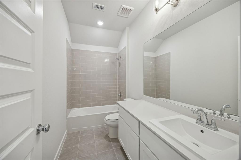 1461 Companero Street Haslet, TX 76052 - Photo 28 of 35 a bathroom with a bathtub shower sink mirror and toilet
