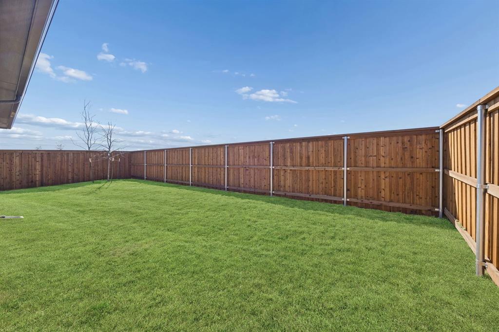 1461 Companero Street Haslet, TX 76052 - Photo 33 of 35 a view of a backyard with wooden fence