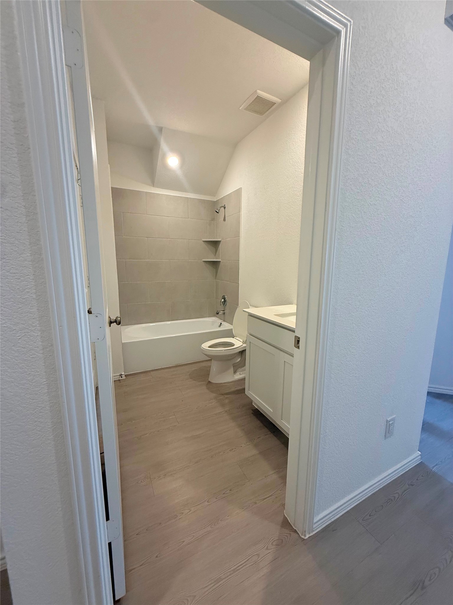 192 Rodney Boat Road Kyle, TX 78640 - Photo 34 of 40 A well-appointed bath boasts a sleek vanity and modern tub with tiled surround.