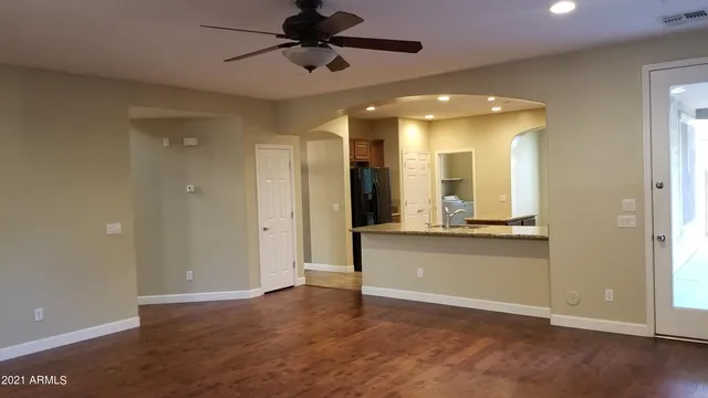 a view of a hallway with wooden floor and a cabinet