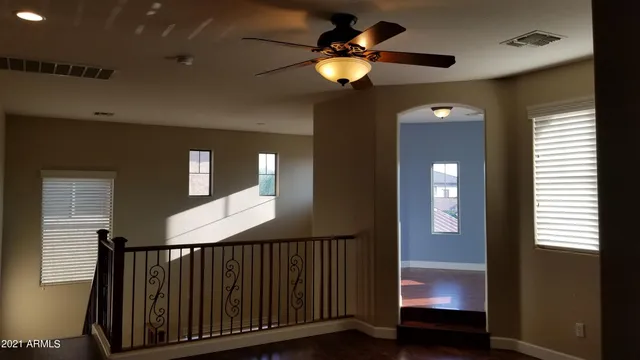 a view of a livingroom with a fireplace and a hallway